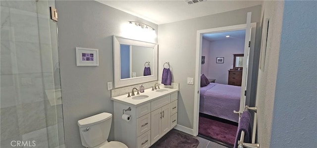 bathroom featuring a shower with shower door, toilet, ensuite bath, tile patterned flooring, and vanity