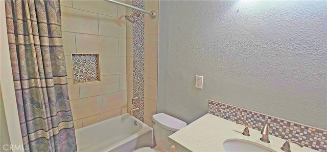 bathroom featuring a sink, toilet, shower / tub combo, and a textured wall