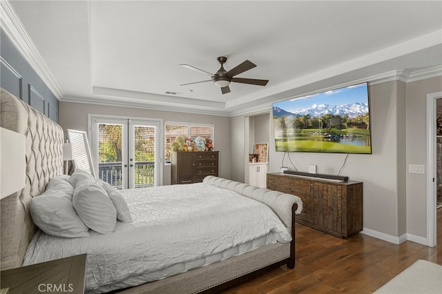 bedroom featuring a tray ceiling, ornamental molding, hardwood / wood-style flooring, access to exterior, and french doors