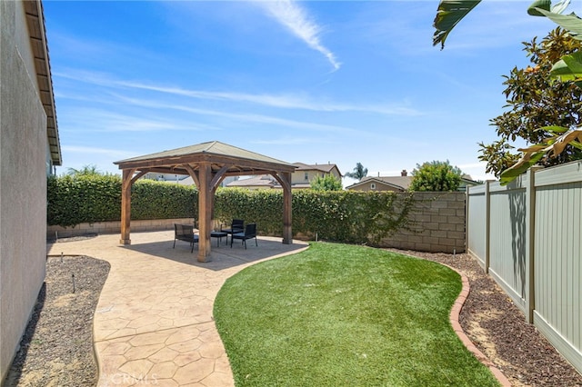 view of yard featuring a patio area, a gazebo, and a fenced backyard