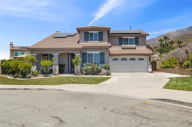 mediterranean / spanish home featuring a tile roof, concrete driveway, a garage, and stucco siding