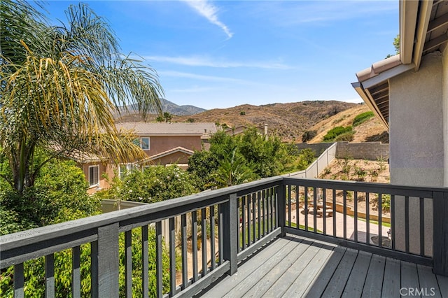 deck featuring a mountain view and fence