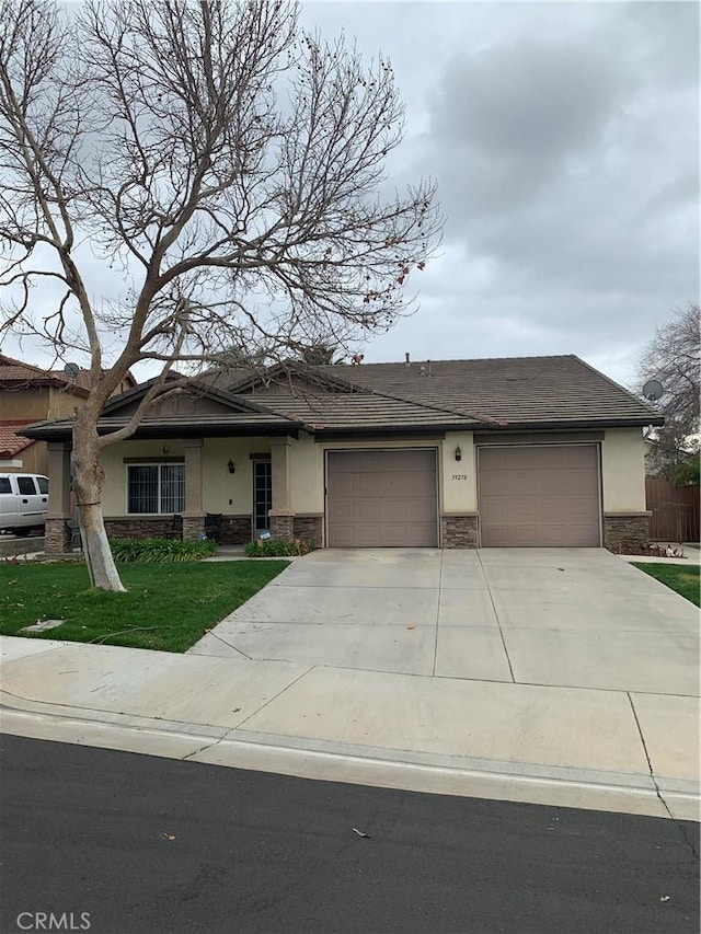 view of front of home featuring stucco siding, driveway, a front lawn, stone siding, and an attached garage