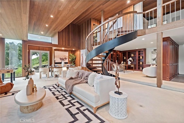 living room featuring recessed lighting, stairway, carpet floors, wooden ceiling, and a towering ceiling