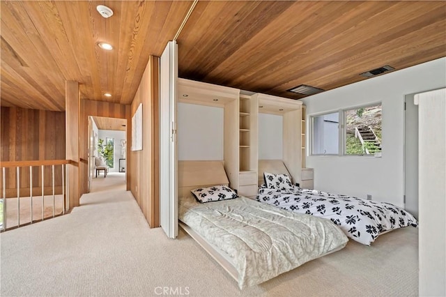 bedroom with wooden ceiling, wooden walls, recessed lighting, and carpet