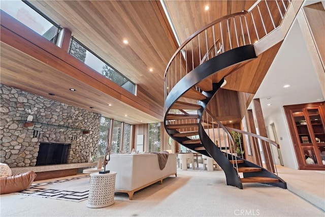 living room featuring a fireplace, stairway, recessed lighting, and carpet