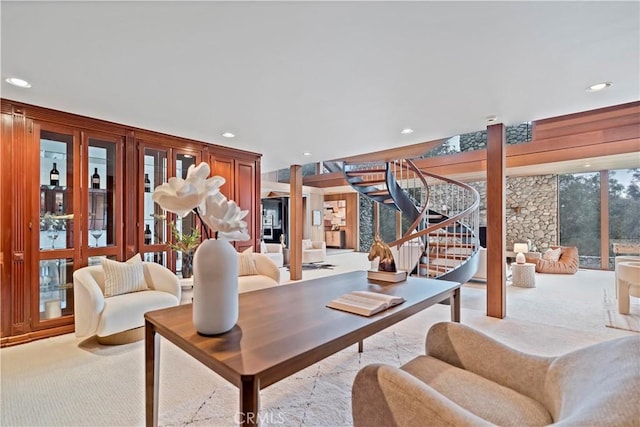 carpeted living area featuring recessed lighting and stairs