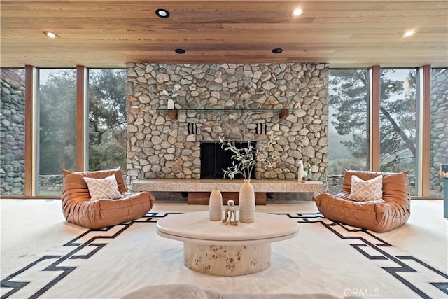 carpeted living room with recessed lighting, wood ceiling, plenty of natural light, and expansive windows