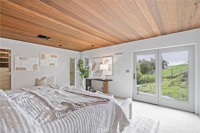 carpeted bedroom featuring access to exterior, visible vents, and wooden ceiling