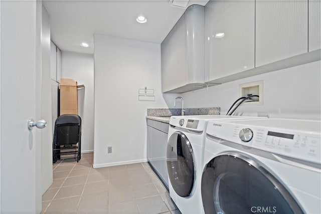 washroom featuring baseboards, cabinet space, recessed lighting, a sink, and washing machine and dryer