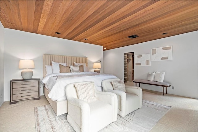 bedroom featuring a spacious closet, visible vents, light colored carpet, and wood ceiling