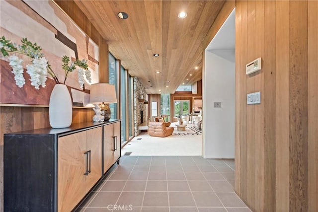 corridor with recessed lighting, wood ceiling, and tile patterned flooring