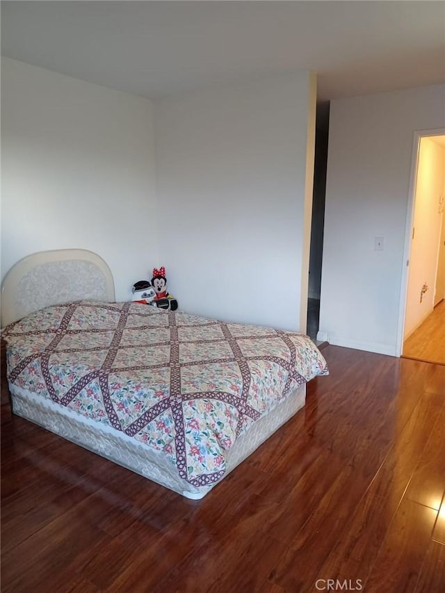 bedroom featuring wood finished floors