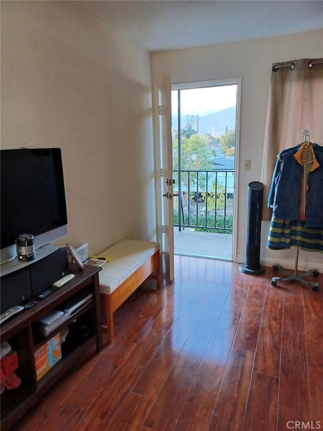 interior space with baseboards and wood finished floors