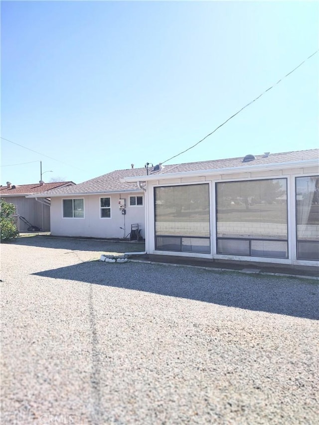 view of front of house with a patio and stucco siding