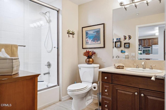 full bath featuring enclosed tub / shower combo, toilet, and vanity