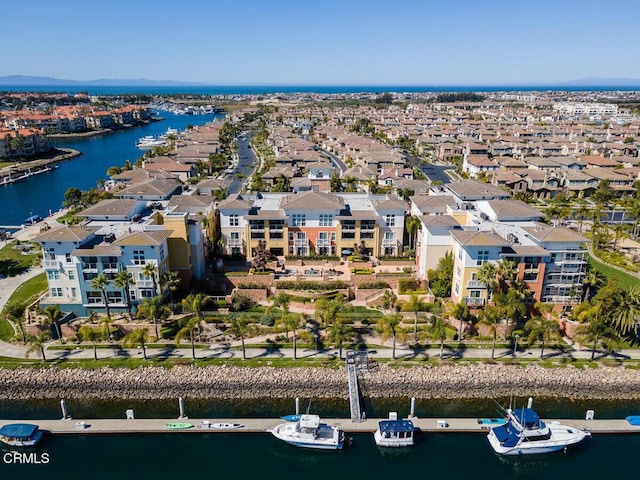 drone / aerial view featuring a water view and a residential view