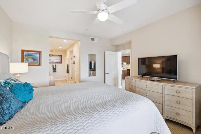 bedroom with ensuite bath, a ceiling fan, and visible vents