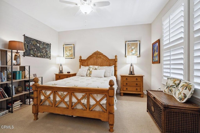 bedroom with multiple windows, a ceiling fan, and carpet floors