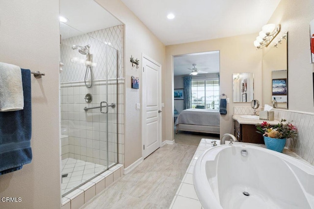 bathroom with vanity, a ceiling fan, a stall shower, ensuite bathroom, and a garden tub