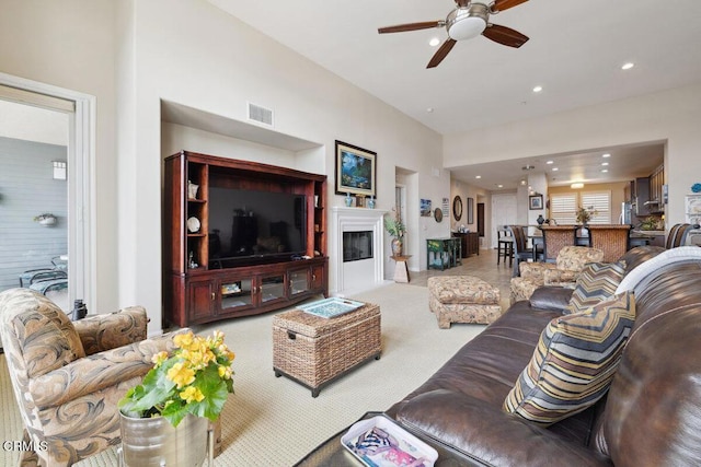 carpeted living room featuring visible vents, recessed lighting, a fireplace, and a ceiling fan