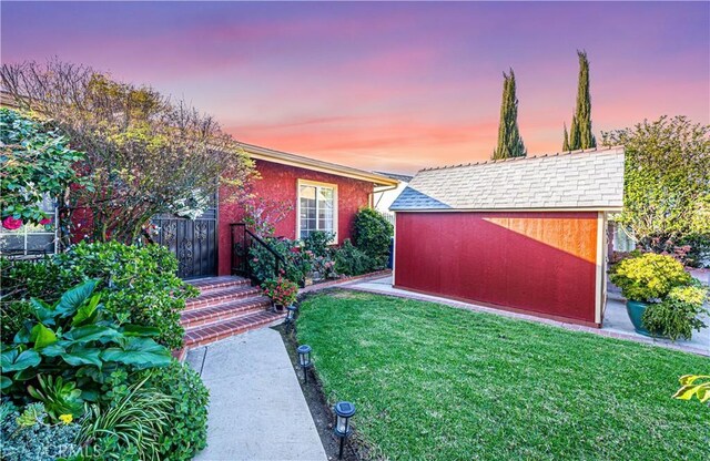 view of yard with a storage shed and an outdoor structure