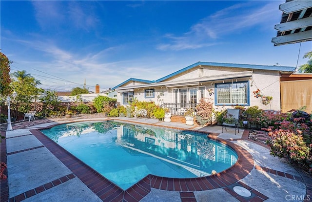 view of swimming pool with a patio area and a fenced in pool