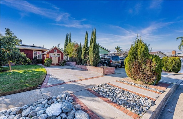 view of front of house featuring a front lawn and roof mounted solar panels