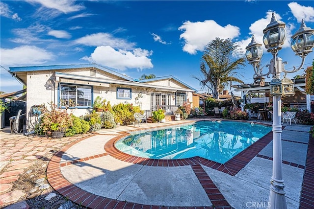 pool featuring a patio area and a pergola