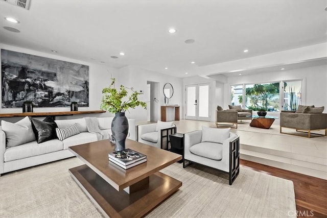 living room featuring visible vents, recessed lighting, french doors, and wood finished floors