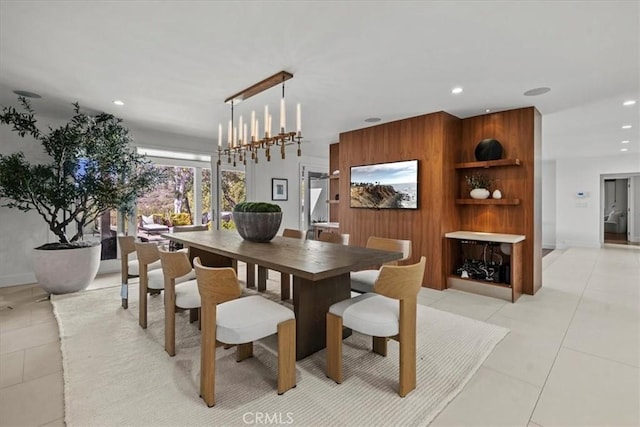 dining space with light tile patterned floors, recessed lighting, baseboards, and wood walls