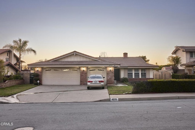 ranch-style house with fence, driveway, an attached garage, a chimney, and brick siding