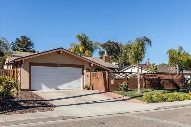 ranch-style home with a gate, stucco siding, concrete driveway, a garage, and a fenced front yard