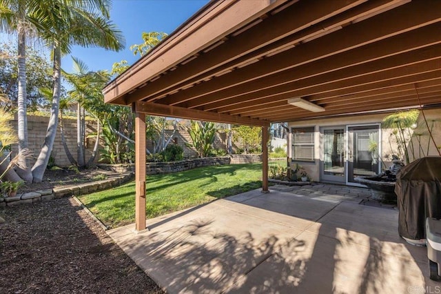 view of patio / terrace featuring french doors, fence, and grilling area