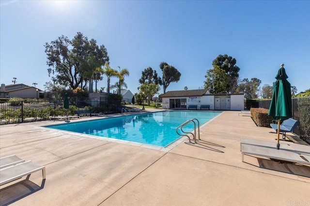 pool with fence and a patio area