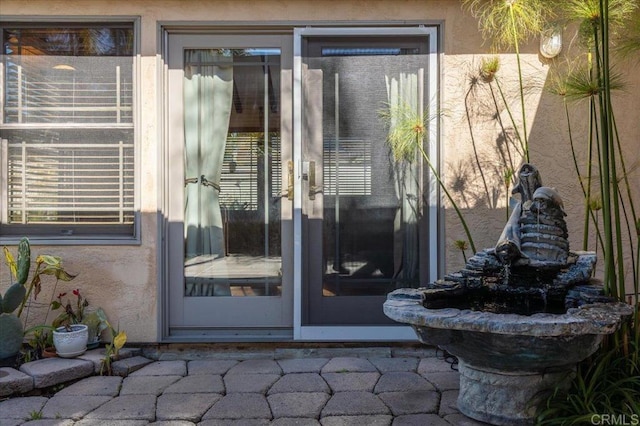 property entrance featuring stucco siding