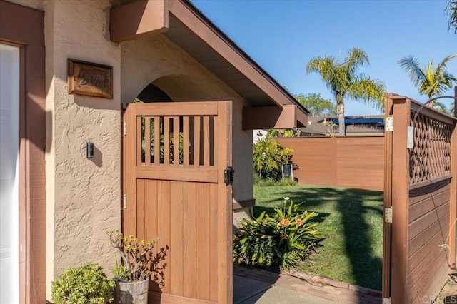 details featuring fence and stucco siding