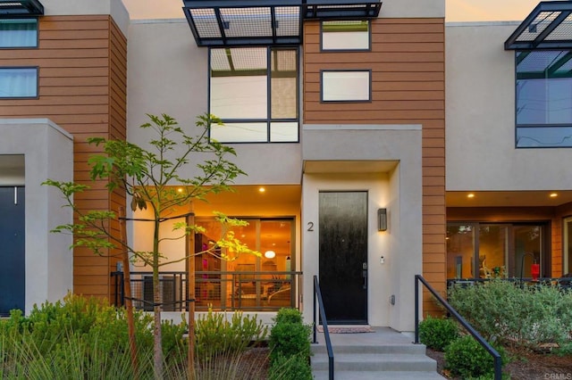 doorway to property with stucco siding