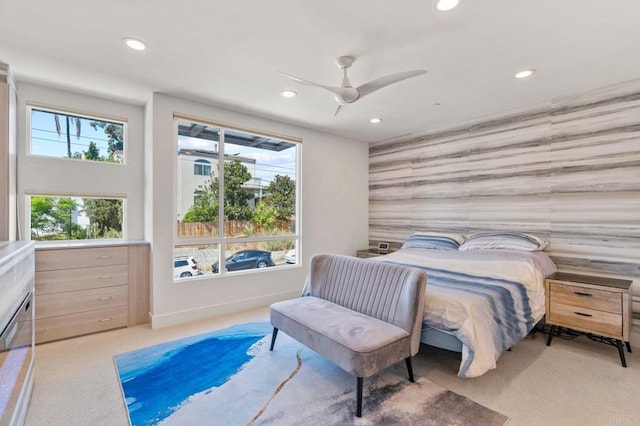 bedroom with light carpet, a ceiling fan, recessed lighting, baseboards, and an accent wall