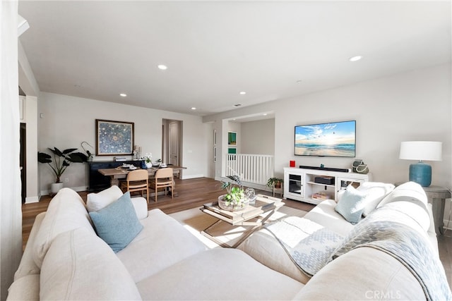 living area with recessed lighting, wood finished floors, and baseboards