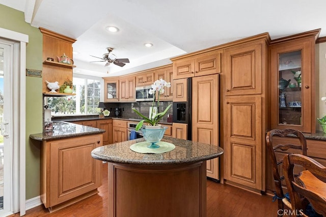 kitchen with open shelves, stainless steel appliances, glass insert cabinets, and dark wood-type flooring