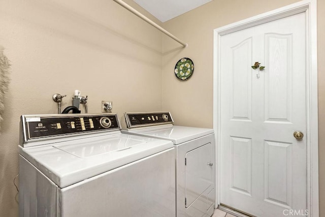 washroom featuring laundry area and washer and clothes dryer