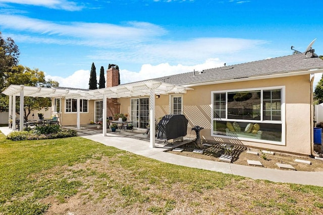 rear view of property with stucco siding, a lawn, a chimney, a pergola, and a patio