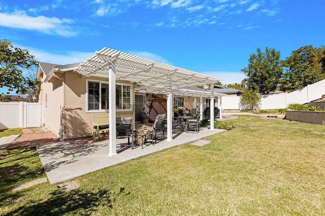 back of property with a patio, a yard, a fenced backyard, a pergola, and stucco siding