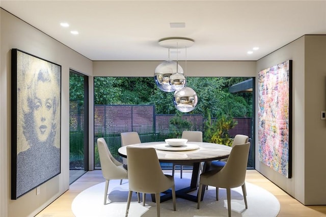 dining room featuring recessed lighting and light wood-style flooring