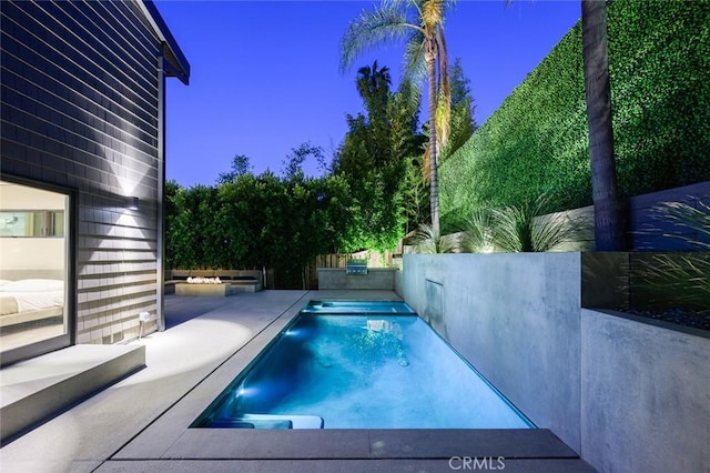 pool featuring a patio and fence