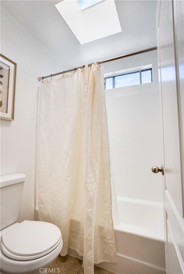 full bath featuring tile patterned floors, shower / bath combination with curtain, toilet, and a skylight