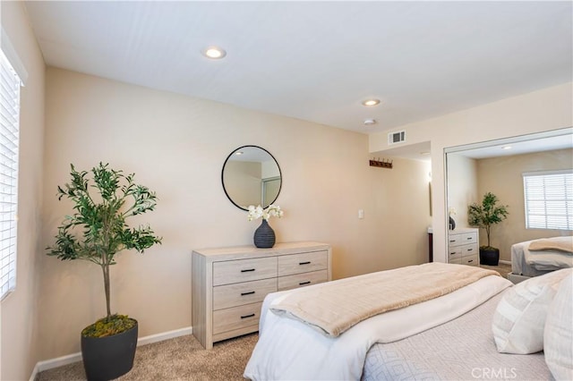 bedroom featuring recessed lighting, light colored carpet, visible vents, and baseboards