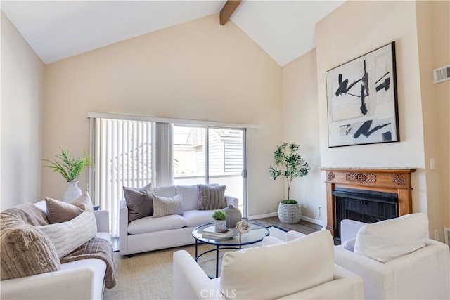 living area featuring visible vents, baseboards, high vaulted ceiling, a fireplace, and beamed ceiling