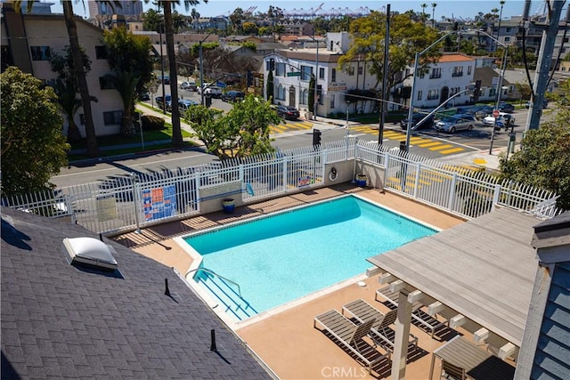 pool with a residential view and fence